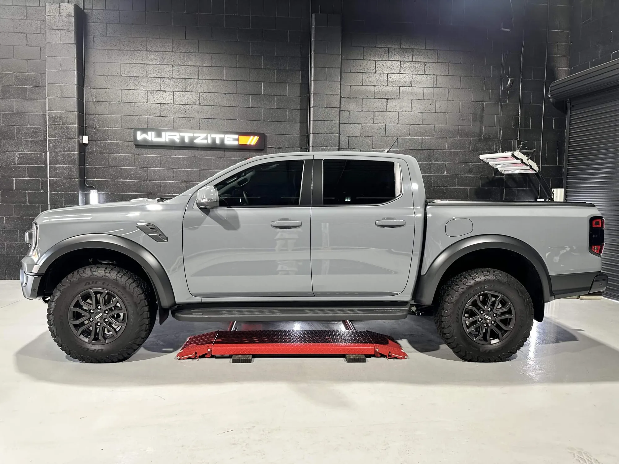 Grey Ford Ranger Raptor on the workshop floor with the glass freshly tinted