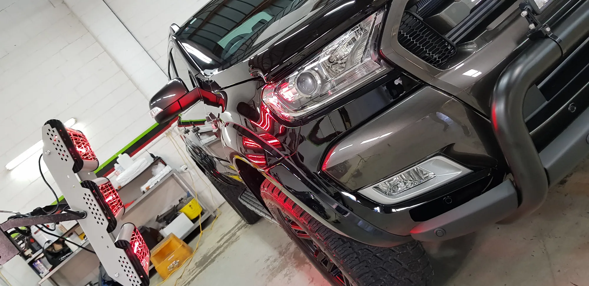 Grey Mercedes X-Class ute with a bull bar under the Ceramicar workshop lights