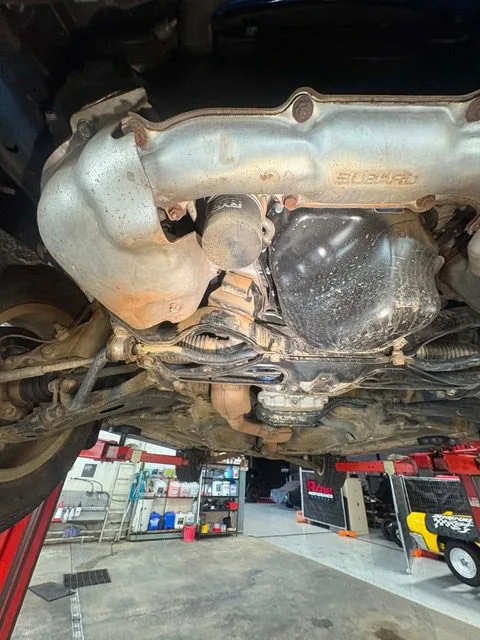 Exhaust manifold and catalytic converter under a vehicle on the workshop hoist