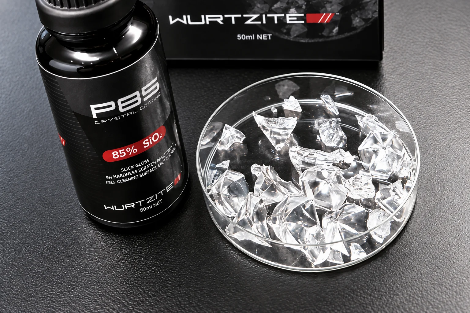 Wurtzite P85 crystal coating 50ml bottle and box beside a glass dish of the clear cured crystal it forms on paint